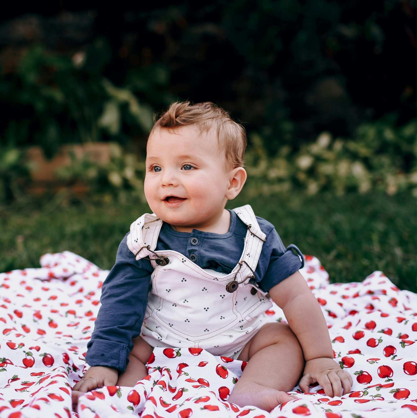 Baby enjoying first summer outdoors in lightweight breathable clothing with proper sun protection