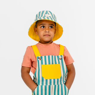 Boy wearing green striped Sunkin hat with matching overalls