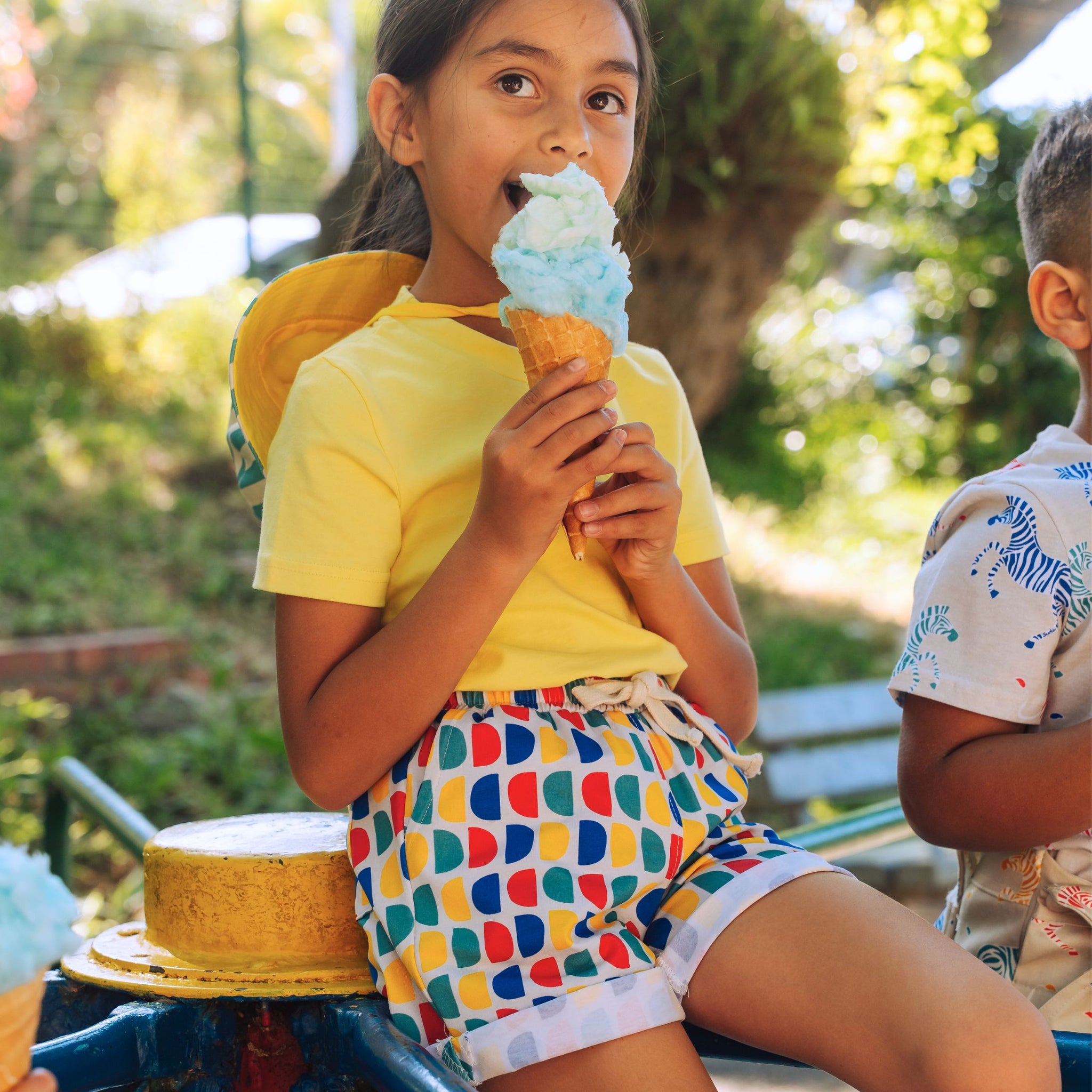 Girl eating ice cream wearing bright Ub blocking clothes