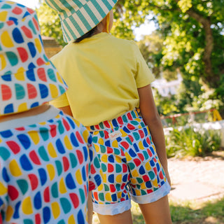 child wearing Sunkin UV protective shorts in D print back view