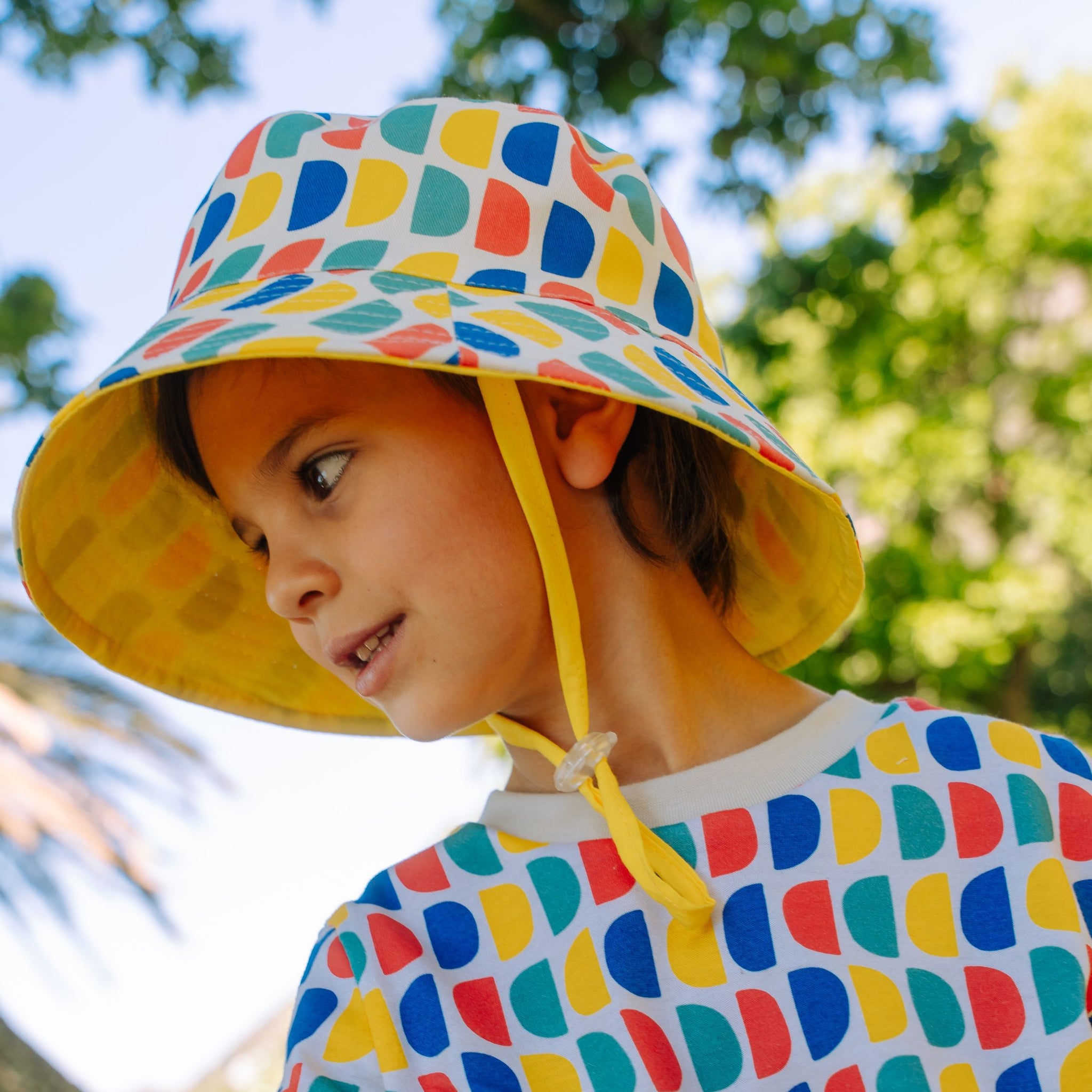 toddler in a Sunkin sun-safe hat with wide brim by SunKin