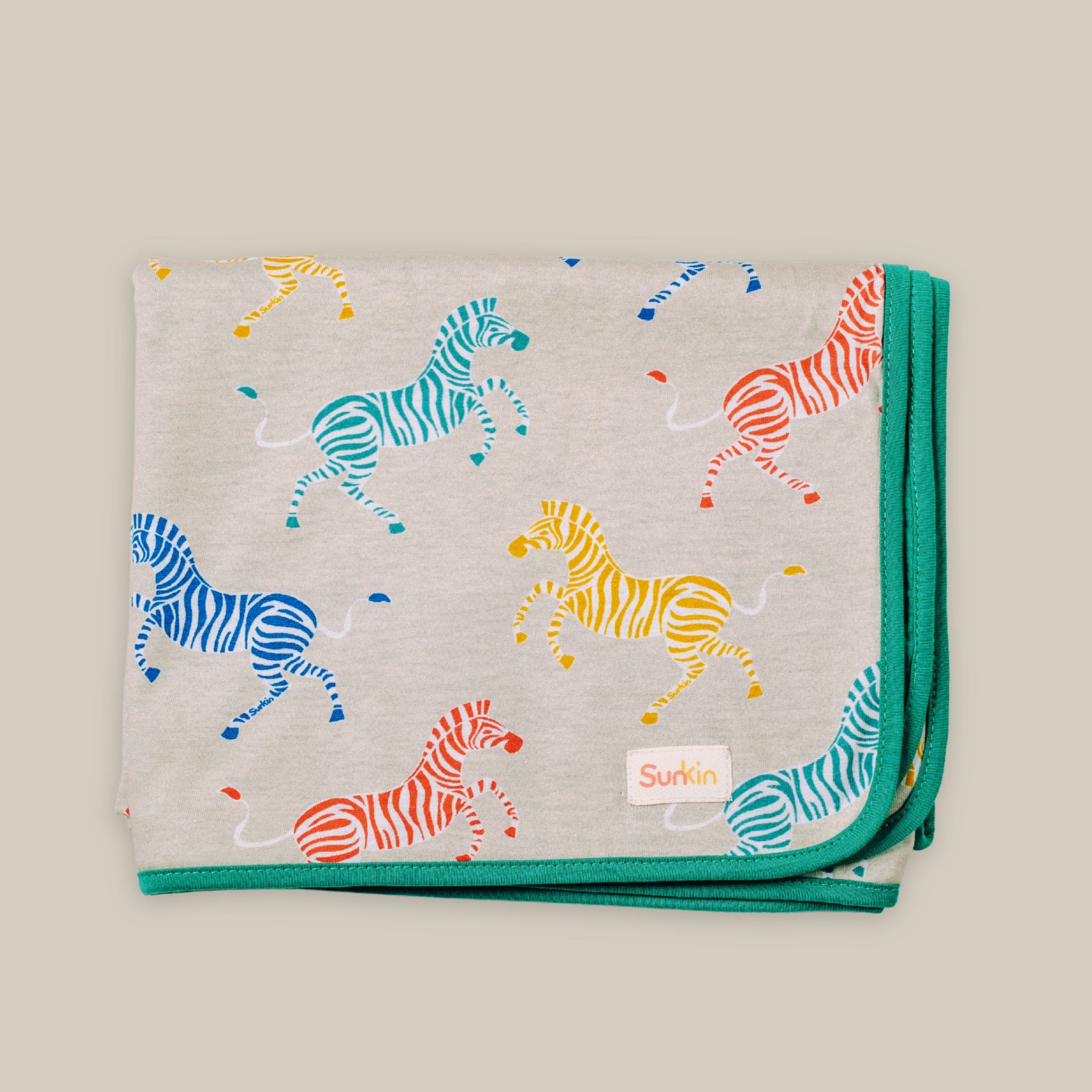 Sun Blanket in zebra print with green on reverse for skin coverage on sunny days