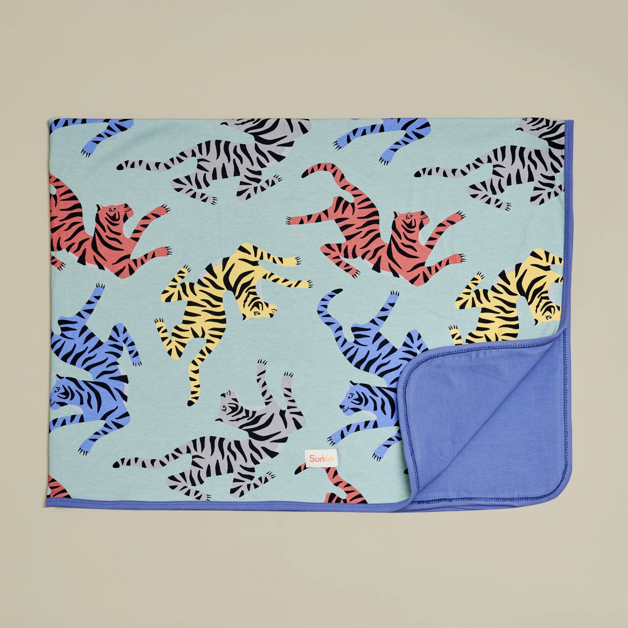 Reversible UPF50+ kids blanket in playful tiger print—made from breathable, CANSA-endorsed cotton fabric by SunKin.
