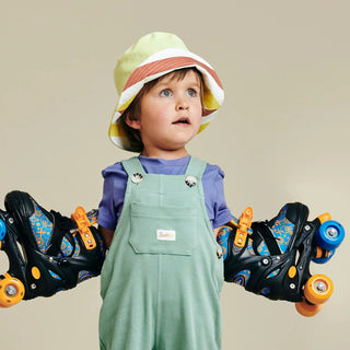 Child wearing SunKin’s Yellow Multi Stripe UPF50+ bucket hat—playful and protective with breathable cotton and built-in sun safety.
