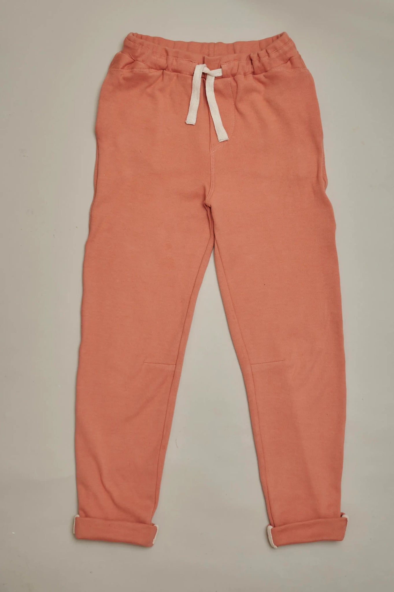 Front view of SunKin’s Apricot UPF50+ slim-fit joggers for kids—lightweight cotton with deep side pockets and elastic waistband.