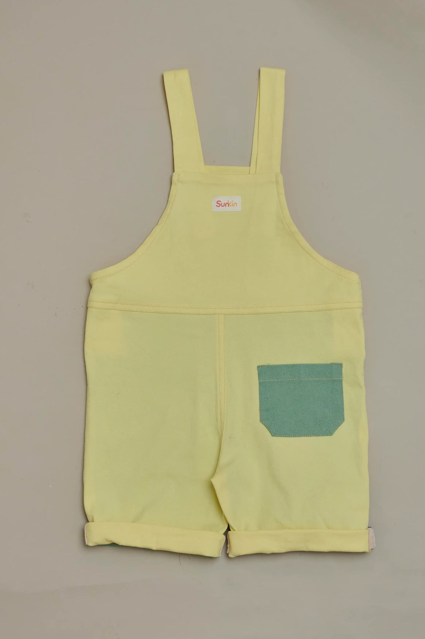 Back view of SunKin’s multicolour shortaree—sun-safe cotton dungarees with playful colour blocking and relaxed fit.