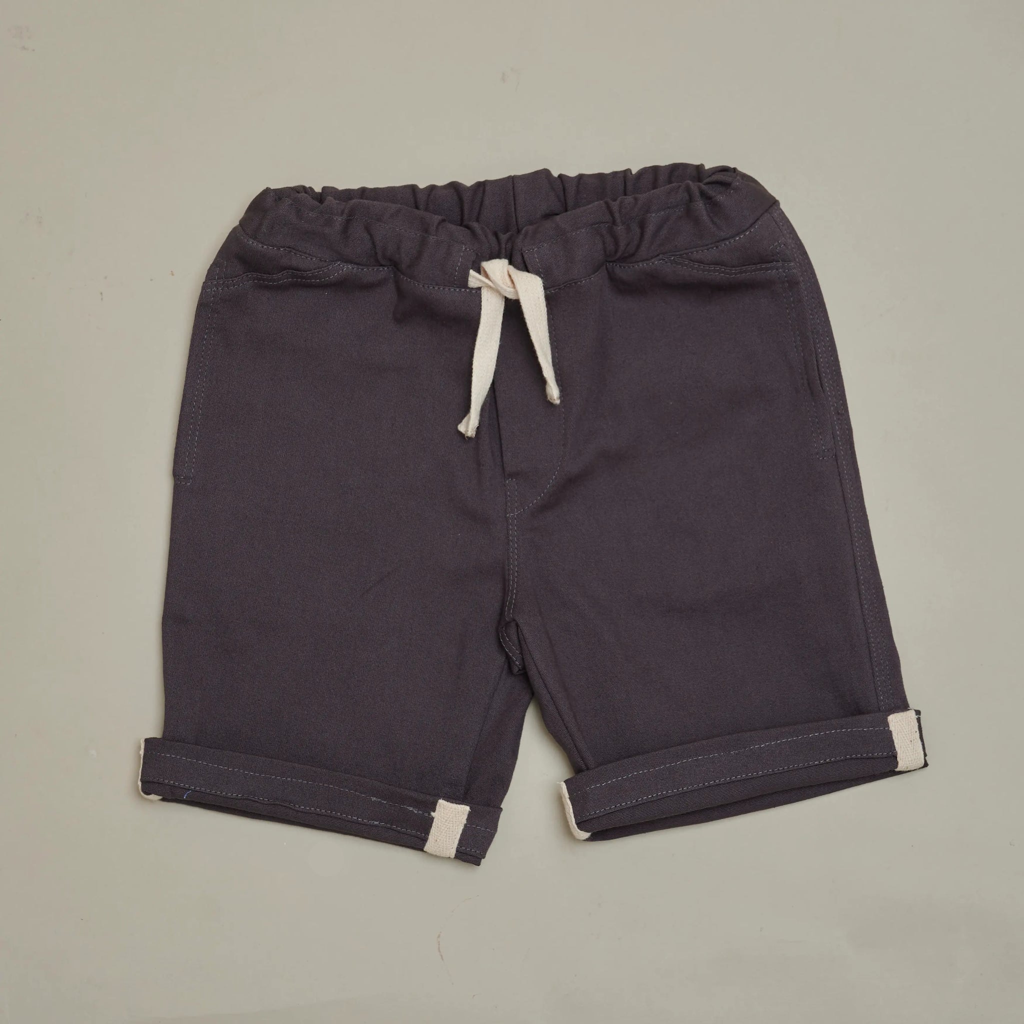 Front view of SunKin’s UPF50+ Dark Grey Woven Shorts for kids—mid-length with elastic waist, drawstring, and side pockets.