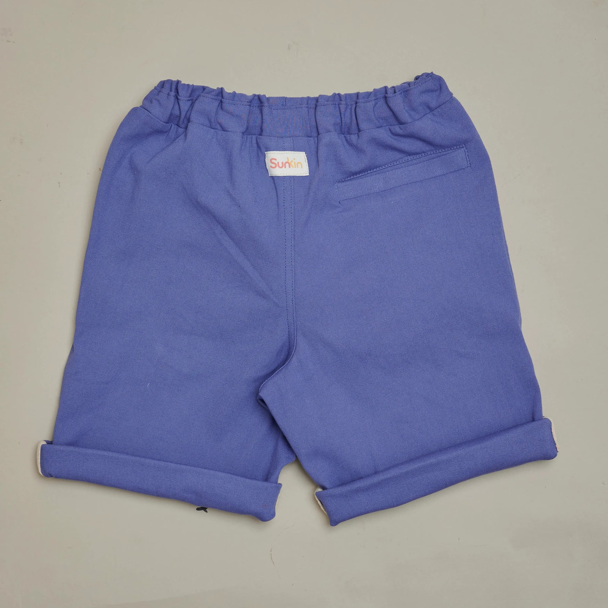 Back view of Violet UPF50+ kids shorts by SunKin—features mid-length cut, contrast inner hem, and back pocket