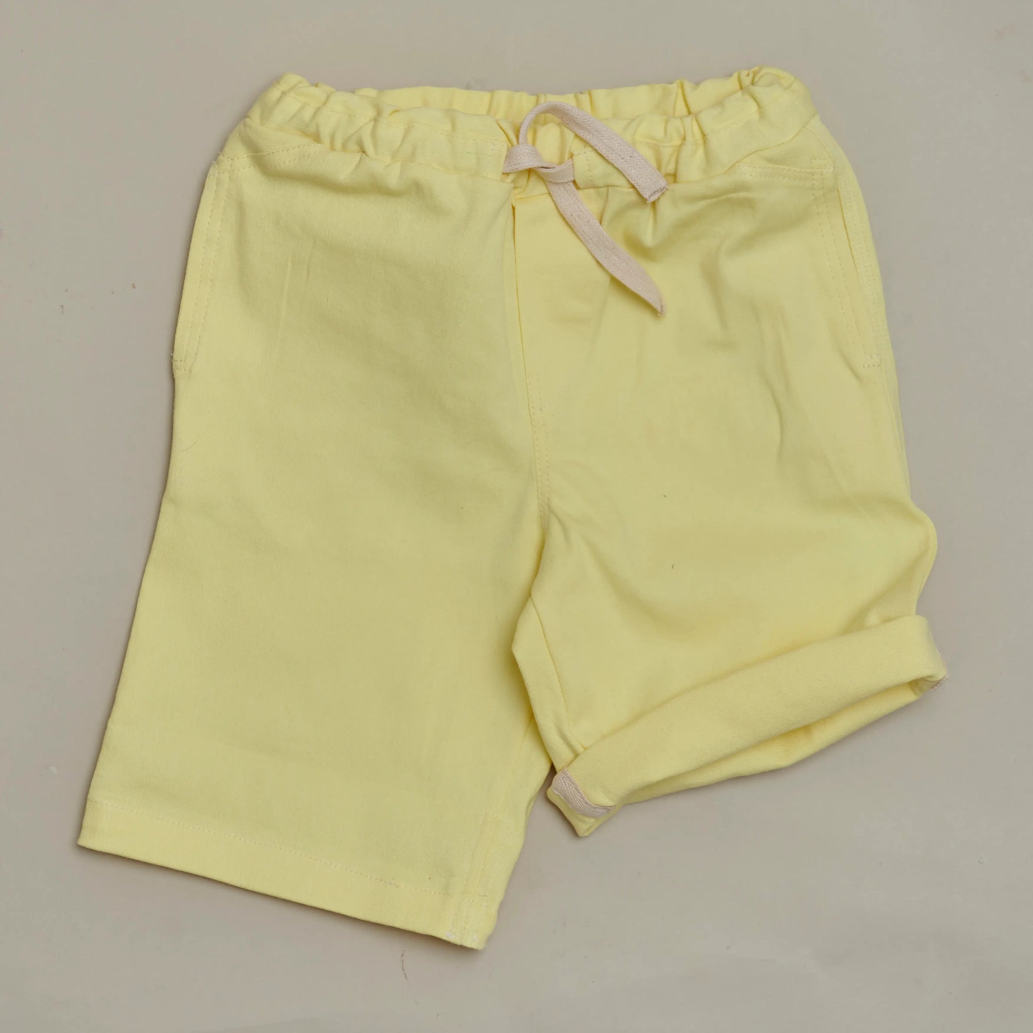 Front view of SunKin’s Yellow UPF50+ woven shorts—lightweight cotton with elasticated waistband, drawstring, and side pockets.