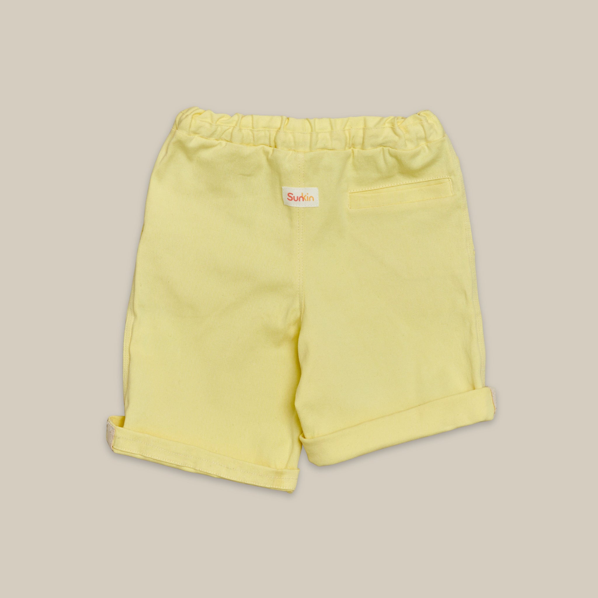 Back view of kids yellow shorts in twill
