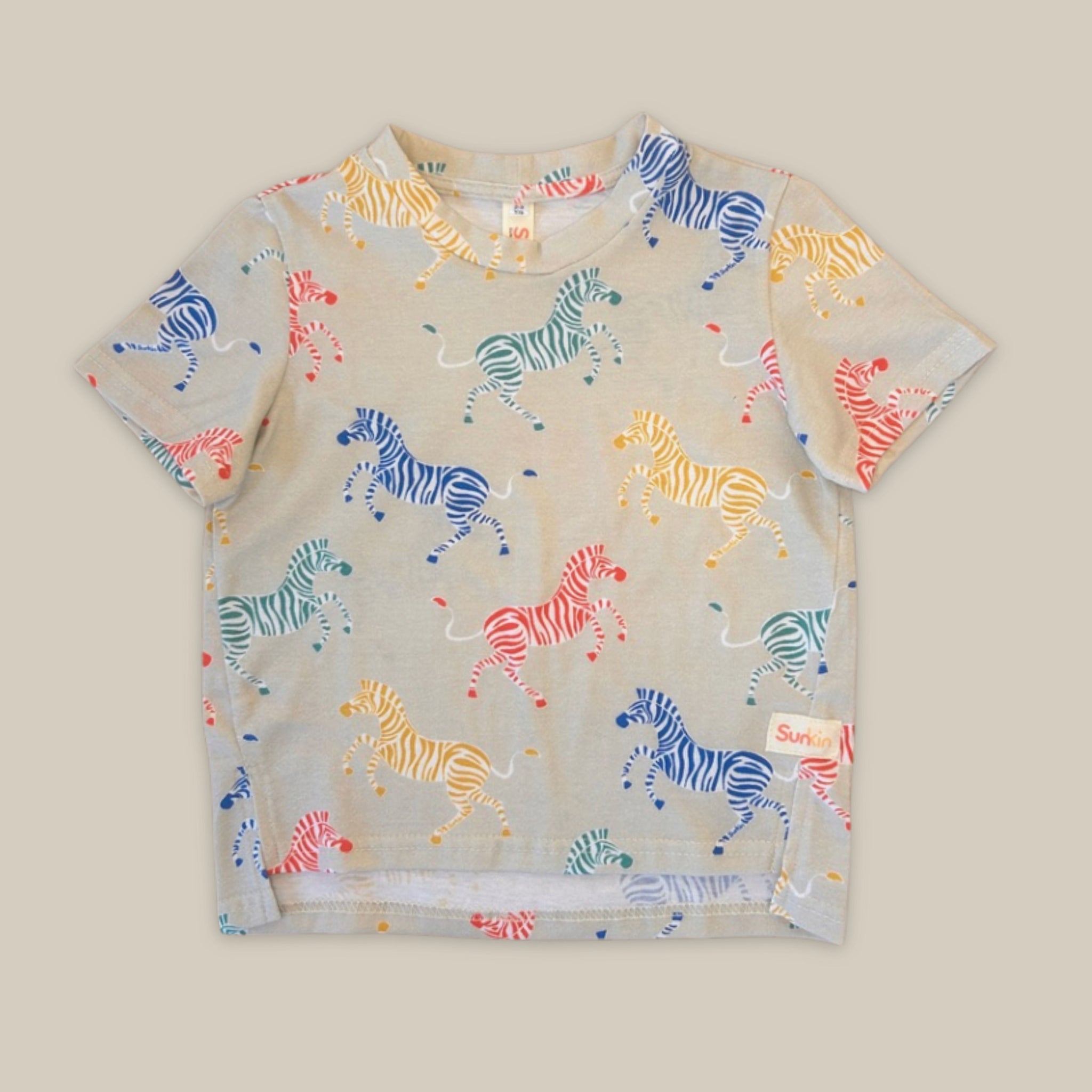 Children's t-shirt with colorful zebra pattern on a beige background
