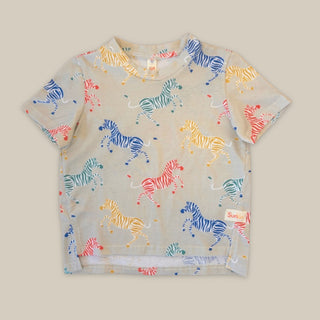 Children's t-shirt with colorful zebra pattern on a beige background